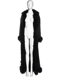 For Sale on 1stDibs - ▪ Christian Dior black full-length coat ▪ Designed by John Galliano ▪ Mongolian lamb with lace overlay ▪ Heavyweight ▪ Large button fastening at the waist