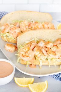 This Shrimp Po Boy is the ultimate sandwich for seafood lovers! Tender shrimp drizzled with creamy, Cajun sauce topped with cabbage on a roll.