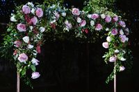 We had this copper arch custom made which is available for rent, and decorated it with flowers for a wedding. The large blossoms in the photo are Secret Garden Rose. Notice the decoration shaped like a heart.