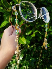 Elevate your eyewear game with our Green and gold glasses chain featuring a stunning combination of green prehnite and yellow citrine crystals. This unique glasses chain is perfect for those who love celestial themes, as it features moon, star, and sun charms that will make you feel out of this world! The chain comes in both gold and silver colors, making it a versatile accessory for any outfit. Plus, the prehinte and citrine crystals are believed to bring positive energy and abundance to your life, making this glasses chain not just a stylish accessory, but also a meaningful one. This eyeglass chain might be slightly heavier than regular chains because of some stone beads and crystals. Actual colors of any item or chains may slightly differ from screen to screen due to the screen resoluti