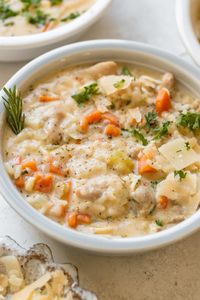 This comforting Creamy Chicken and Rice Soup comes together in a flash and is loaded with tender, juicy chicken pieces, veggies, rice and a creamy broth. The rice cooks right into the soup so it gives this soup body and richness and really thickens the broth thanks to the starch. It's the comfort food you crave after a long day! Enjoy with parmesan and parsley on top and enjoy! #chickenandrice #ricesoup #chickensoup #30minutesoups #easysouprecipes #krollskorner #soupseason #chickenrecipes 