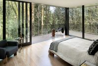 Black wood and glass volumes form Royal house in Oregon woodland