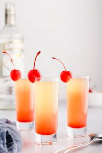 This colorful 3 ingredient pineapple upside down cake shot is sweet and fruity with layers of pineapple juice, vanilla vodka, and grenadine.