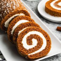 This classic Pumpkin Roll recipe is made EASY with one simple trick that keeps it mess-free! Enjoy the best soft pumpkin cake filled with a delicious cream cheese filling. Perfect for fall desserts, Thanksgiving dessert ideas, or a treat for a crowd, this pumpkin roll is a must-try. It’s moist, flavorful, and a 5-star recipe everyone will love!