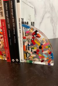 "Super fun art piece handmade bookend made with transparent resin and pills. This listing is for each end. *Please keep in mind that each bookend is equivalent to 6 coasters and the price reflects the amount of time and materials it takes to make. 5\" Tall x 4\" Wide x 2\" Deep Our art resin is BPA free and food safe and can be used on cutting boards, tumblers, and other kitchen items. High quality, non-toxic, art resin with zero VOCs and odor free is always used. All epoxy resin may yellow over