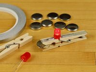 A simple coin cell battery holder tester using a red LED, some Maker Tape, and a clothespin.