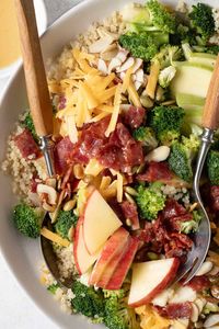 This Broccoli Cheddar Quinoa Salad recipe is made with quinoa, broccoli, cheddar cheese, apples, nuts and seeds and maple vinaigrette.