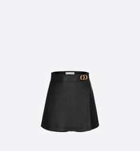 The skort is both modern and timeless. Crafted in black smooth lambskin, the design features a corolla cut embellished with a gold-finish 'CD' buckle at the hip and a rear patch pocket. The shorts will lend the finishing touch to a solid or patterned blouse.