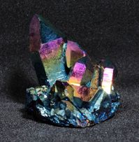 This Rainbow titanium coated quartz crystal cluster while small is bursting with bright and ever changing colors from any angle you look at it.   Small is mighty! Identification: Rainbow Titanium Coated Quartz Dimensions (cm):3.0 x 2.9 x 2.6 cm (height tallest crystal x length of base x width of base) Weight: 16.5 grams Origin: Bear Mountiain, Arkansas Treatments: Titanium coated to get rainbow effect.  The integrity of the quartz crystals is not affected by the coating process. Colors will not