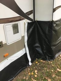 Homemade DIY RV trailer skirting from billboard tarp vinyl for around $200 to get ready for cold weather winter camping