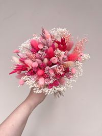 This bouquet is definitely one for all of the pink lovers! Combining dusty, light and hot pink shades with. a touch of creamy white. Perfect for a pink interior, gift for your loved ones or for your wedding! We only use the highest quality dried and preserved flowers in all of our hand-crafted bouquets, creating beautiful bouquets and arrangements to suit every interior! All of our bouquets are perfect gifts for every occasion - send your loved ones a beautiful, long-lasting bouquet that they will treasure. Approx. Measurements: MINI/FLOWER GIRL: 30-35cm tall x 15cm wide STANDARD/BRIDESMAID: 40cm tall x 25cm wide LARGE/BRIDAL: *NOT PHOTOGRAPHED* 40-45cm tall x 32-35cm wide **Please check measurements of the bouquet before ordering** --- SENDING THIS BOUQUET AS A GIFT? --- Free gift message