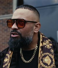 Bold Square Frame Sunglasses with Amber Tinted Lenses and Black Acetate Frame Worn by Guz Khan as Chucky in The Gentlemen