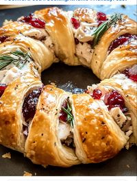 1 tube crescent rolls 4 oz chive and onion cream cheese 1 1/2 tbsp Dijon mustard 3 tsp finely chopped fresh rosemary or thyme, divided 2 cups shredded Gruyere cheese, divided 1 lb thinly sliced turkey 1 (14 oz) can whole berry cranberry sauce 2 tbsp butter, melted 1/2 tsp poppy seeds 1/2 tsp granulated garlic 1/4 tsp salt  Preheat oven to 375°F Line a large baking sheet with parchment paper  Separate crescent rolls widest portion inside and edges overlapping.  Filling: whisk cream cheese, Dijon mustard, and 1 tsp of rosemary or thyme. Spread Sprinkle with 1 cup of shredded cheese. Arrange turkey slices over cheese, Spread half cranberry sauce over turkey and top with remaining cheese.  mix together melted butter, poppy seeds, garlic, and salt.   Bake for 22-24 minutes until golden.