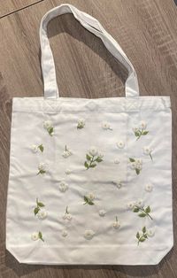 "- Canvas tote bag with beautiful floral hand embroidery - Approx. measurements:  14\"x 1 2.5\", handle 20\"                                              (35cm x 32cm/ handle 50cm) - Materials: 100% cotton - Care: Handwash, recommended using cold water and hanging to dry Thank you for visiting my shop!  Please have a look at the other products: Hand Embroidered Canvas tote bag: https://www.etsy.com/your/shops/MMCraftsHome/tools/listings/section:41577731,sort:stock Hand Embroidered Hair Accessori