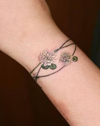 Clover flower bracelet tattoo in watercolor style.