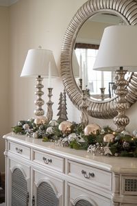 Elevate your dining room sideboard with elegant Christmas decor. Silver ornaments and candle holders create a festive yet refined display.