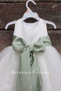 Pretty Sage Big Bowknot White Satin Tulle Flower Girl Dress features sleeveless jewel neck bodice, puffy A-line skirt at floor length with eye-catching sash. shown color: white no cups no boning back zipper closure fully lined Sash remains sage color as color option changes.