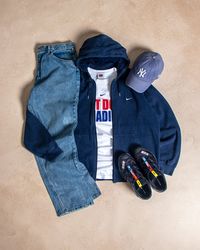 Y2k Nike navy blue zip up hoodie layered over a vintage Nike Montreal Canadiens graphic tee found and the thrift and paired with mid wash blue Tommy Hilfiger denim jeans. Create your best casual winter vintage fits online now!