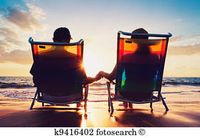 senior couple of old man and woman sitting on the beach watching sunset