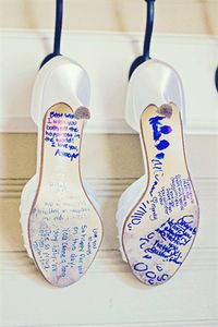 Have your bridesmaid sign your wedding shoes and make it your 'something blue'