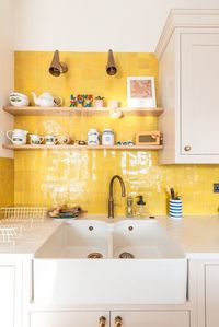 The colour combinations in this space draws you in and makes it feel bright and airy. The cabinets are Herringbone’s Cathedral Stone from the Herringbone Paints Range whilst the island is our Jersey Blue colour from the same range. The bright yellow tiles work well with both colours and created a focal viewpoint.