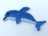 Crochet appliques, Sea life crochet, 1 applique dolphin. This cute crochet dolphin is in dark blue and pale blue. It measures 3¼ ins (8cms) long and 1¾ ins (4cms) across the widest part. It can be used for a wide variety of craft projects including cardmaking, scrapbooking, appliques, craft embellishments and sewing accessories.. It would be perfect to decorate skirts, blouses, sweaters, hats, scarfs, bags, gloves, baby clothes, children's clothes, accessories, cushions, pillows, home decor proj