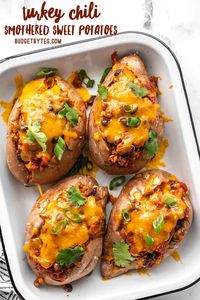 Tender baked sweet potatoes smothered with turkey and bean chili, then topped with melty cheddar. Turkey Chili Smothered Sweet Potatoes are an easy dinner! BudgetBytes.com