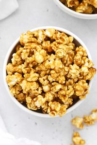 We're spilling our secrets for THE BEST Caramel Popcorn! This easy homemade caramel corn recipe can be made crispy or gooey, and both ways are delicious. Come for the simple ingredients & stay for the flavor! This naturally gluten-free caramel corn is the perfect crunchy snack for movie night, parties, sleepovers, and more. Get the recipe for this crispy caramel popcorn and more sweet treats to try at Sweets & Thank You