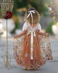 Our burnt orange floral embroidered short sleeve flower girl dress is perfect for fall or BoHo style weddings. Featuring a stunning V-shaped back with eyelash lace and ankle-length skirting, this dress suits toddlers, girls, and junior bridesmaids. Ideal for weddings, family photo shoots, or special occasions. Choose from plain, jeweled, or custom-made floral sashes. Note your sash color and custom flower preferences at checkout. Explore our matching hair accessories available in the menu.