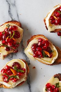 Make this simple festive appetizer for your holiday guests. Toasted baguette slices with creamy, melted brie are topped with an orange-cranberry-pomegranate mixture—each bite delivers an explosion of flavor and texture! #christmas #holidays #christmasfood #christmasdinner #holidaydinner #holidayseason #recipe #eatingwell #healthy