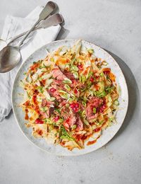 Sabrina Ghayour's punchy salad is inspired by her travels in Bangkok. She matches pan-fried lamb leg steaks with pomegranate seeds, fennel, fresh mint and a rose harissa dressing.