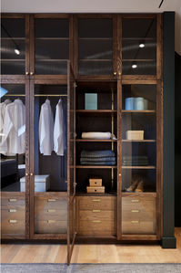 A bespoke minimalist, wooden wardrobe with a clean, modern aesthetic. The handcrafted, wood-framed wardrobe, crafted by master artisans in our workshop, allows light to pass through to reveal its contents behind the fluted glass panels. The custom-made wardrobe creates a dressing room connecting the master bedroom to the ensuite bathroom, so you can easily dress to impress with your best autumn and winter outfits each morning.
#wardrobedesign #bedroomideas #dressingroomideas
#kitchenarchitecture