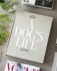 Dedicate a photo album to the life of your four-legged family member with this beautiful 'A Dog's Life' Photo Book from PRINTWORKS. Each page can fit two 4x6 in photographs, with space for personal notes below, so you can preserve your special memories. Details + Design: 30 pagesMaterial: Cover: 100% Cotton fabric + recycled greyboard. Pages FSC-certified, acid-free white card. Black metal binder. Weights + Dimensions: Height: 13 in. Width: 10.6 in. Depth: 2 in. Weight: 2.8 lbs. Imported | PRINT