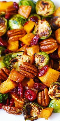 Roasted Brussels Sprouts, Cinnamon Butternut Squash, Pecans, and Cranberries (and maple syrup). YUM! Side dish recipe.