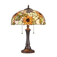 This is a Floral style 2-light table lamp features a delicate set of bright sunflowers, and light green leaves over a peach back ground. This piece is hand crafted from over 260 pieces of art glass. Handcrafted using the same techniques that were developed by Louis Comfort Tiffany in the early 1900s, this beautiful Tiffany-style piece contains hand-cut pieces of stained glass, each wrapped in fine copper foil and soldered using high heat. Dry listed and recommended indoor use only. Color: Bronze