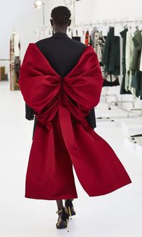 An Alexander McQueen Autumn/Winter 2018 tuxedo jacket is finished with a carmine silk bow, draped and wrapped like a chrysalis. Photograph by Sir Don McCullin.