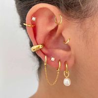 Elegant and timeless, these Pearl Hoop Earrings feature a classic hoop design adorned with delicate pearl drop. Perfect for adding a touch of grace to both everyday and special occasions. 925 Sterling Silver Gold Plating Hypoallergenic Tarnish Resistant