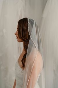 FREE DELIVERY WORLDWIDE! Introducing the Pearl Mantilla Wedding Veil, this unique pearl edged bridal veil is trimmed with off white pearls that are hand stitched around the whole edge of the embellished veil. With vintage pearl luxury it is designed to be worn as a pearl cap veil. Your veil can become a heirloom veil that is passed down through generations.  LENGTH OPTIONS:  Choose from various lengths, including waltz, floor, chapel, cathedral, princess or royal all crafted with the highest qua