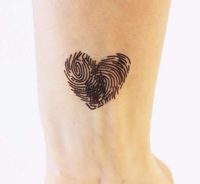 Two fingerprints come together to make a heart. This is one of the most unique heart tattoo ideas. This would be a great way to incorporate your own prints or someone else’s, or maybe a combination of the two. Color can also be added to change it up. #tattoofriday #tattoos #tattooart #tattoodesign #tattooidea