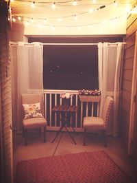 Small apartment patio with lights strung at night <3