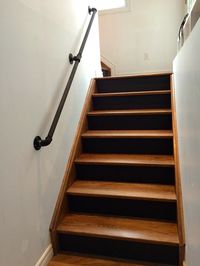 gas pipe railing, walnut stairs, black risers                                                                                                                                                                                 More