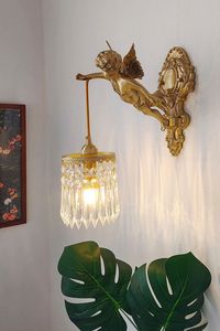 This elegant of  statuary wall lamp adds a touch of charm to any room. Handmade by our skilled artisans, this fixture includes a putti little angel. The detailing  is breathtakingly realistic and highlights the handiwork applied to this piece. From a functional standpoint, this makes for a very durable and functional lighting component. Therefore it donates a warm premium look to your home. Also it easily combines with lots of colors.   Note: If you need to buy two, please buy the size with this