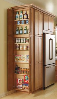 This Utility Cabinet's adjustable shelves make storing all of your pantry items easy and give you the space you need. By Thomasville Cabinetry.