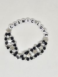 Visit bejeweledbangles.com for better pricing! This gorgeous bracelet is made of black and silver metal beads with accent stars, "Cosmic Love" in white beads with black writing. This bracelet is so pretty and you will love wearing it proudly or gift it to a friend! Bracelet is made with elastic and various bead types.