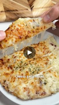 7.4M views · 629K reactions | Say “YUM” if you would eat this Cheesy Garlic Bread 🥖😋🙌

What you need:
2 low carb tortillas
2 oz cream cheese
1/2 cup shredded mozzarella 
2 tbsp melted butter 
1 tsp garlic, minced
1 tsp chopped parsley 

How to make it:
1. Spread your cream cheese on a tortilla and add half of your mozzarella. Top with the other tortilla.
2. Mix the butter, garlic & parsley and brush on each side of the tortillas.
3. Add your final layer of mozzarella to the top & air fry @ 380F for 8-10 mins.
4. Take it out, serve with more garlic butter and enjoy! | iRick Wiggins