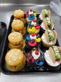 cheeseburger, ice cream sundae, and taco decorated cupcakes with buttercream icing