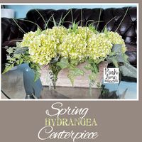 Hydrangea's centerpiece is bursting with elegance and warmth. This farmhouse arrangement would complement any space in your home with the soft green of the hydrangeas and the complimentary greenery. The container is made of rustic wood. Very lightweight. 11 top-quality silk Hydrangeas in total. #hydrangeacenterpiece #springarrangement #summerarrangement