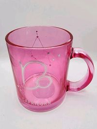 This Modern Expressions Zodiac CAPRICORN Glass Mug Cup in Pink is a perfect addition to your collection. The round mug has a novelty pattern and is made of high-quality glass material. The etched features add a touch of elegance to the mug, making it suitable for all occasions. The 11.8 fl oz capacity mug has a height of 3 3/4" and a diameter of 3 1/8". It is a Celestial & Horoscope themed mug, with the zodiac sign of Capricorn. The mug is manufactured in China and is an excellent gift for anyone who loves novelty mugs. Capricorn is the zodiac sign for birthdays 12/22-1/19. New mug! Product is not micro/dishwasher safe and has temperature limits per lable.