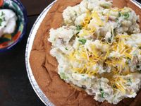 A hollowed-out bread bowl filled with creamy mashed potatoes looks like a potato big enough to feed a party! #LaborDay