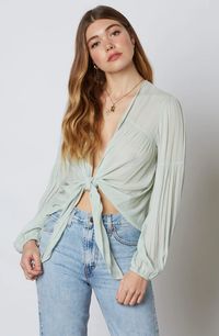 Show off your sense of style in the Gia Sage Long Sleeve Tie-Front Crop Top! Gauzy sage woven fabric cascades into a plunging neckline and cropped, blousy bodice with a tie-front design. Long, puffy lantern sleeves add a dramatic finishing touch to this sultry blouse. Gathered detail on hem and sleeves.